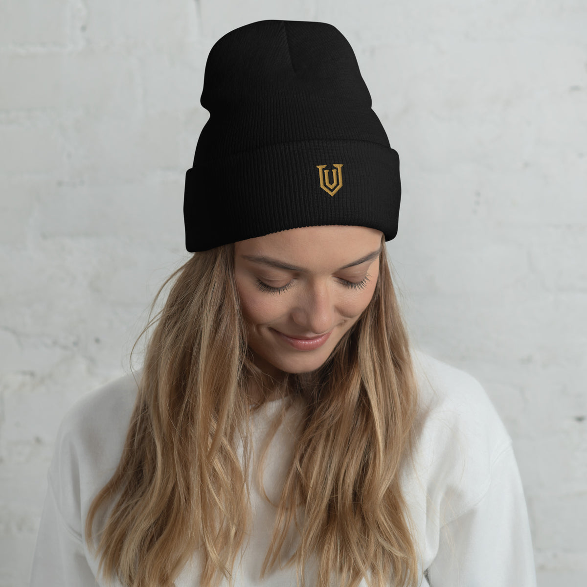 UPBORNE Resolve Beanie in black with Old Gold shield embroidery, modeled view