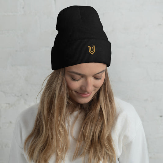 UPBORNE Resolve Beanie in black with Old Gold shield embroidery, modeled view